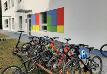 Kolorowa elewacja i rząd rowerów przed szkołą w Baninie – uczniowie chętnie wybierają ekologiczny dojazd. - powiększ