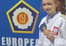 Dziewczyna prezentuje zdobyty medal. - powiększ