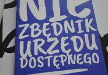 Okładka ulotki 'Niezbędnik urzędu dostępnego'. Białe napisy na niebieskim tle - powiększ