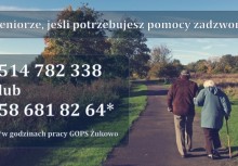 Para seniorów spaceruje drogą. Obok napis: Seniorze jeśli potrzebujesz pomocy zadzwoń 514 782 338 lub 58 681 82 64*. *w godzinach pracy GOPS Żukowo - powiększ